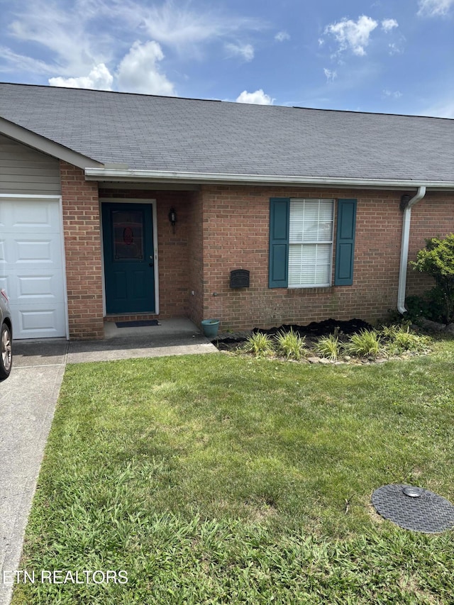8022 Intervale Way, Powell, TN 37849 - doorway to property with brick siding, a lawn, a garage, and driveway