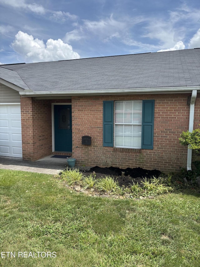 8022 Intervale Way, Powell, TN 37849 - view of front of home with brick siding, a front yard, a garage, and roof with shingles