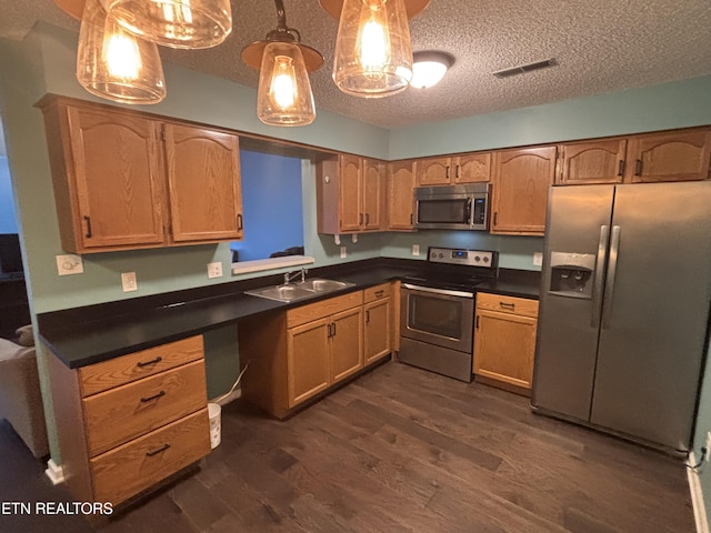 8022 Intervale Way, Powell, TN 37849 - kitchen with appliances with stainless steel finishes, dark wood-style floors, a textured ceiling, dark countertops, and decorative light fixtures