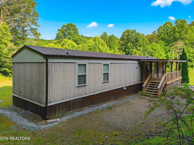 4334 Big Creek Rd, Hartford, TN 37753 - view of front facade with a metal roof and a forest view