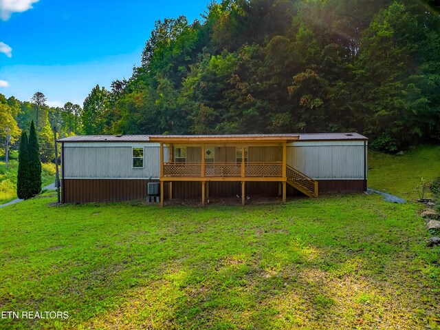 4334 Big Creek Rd, Hartford, TN 37753 - rear view of property featuring a yard, a forest view, and a metal roof