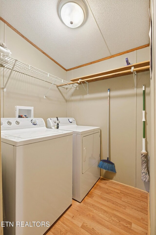 4334 Big Creek Rd, Hartford, TN 37753 - laundry room with washer and dryer, light wood finished floors, ornamental molding, and a textured ceiling