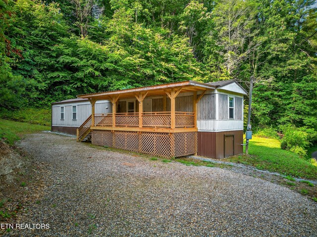 4334 Big Creek Rd, Hartford, TN 37753 - manufactured / mobile home with a porch and a forest view