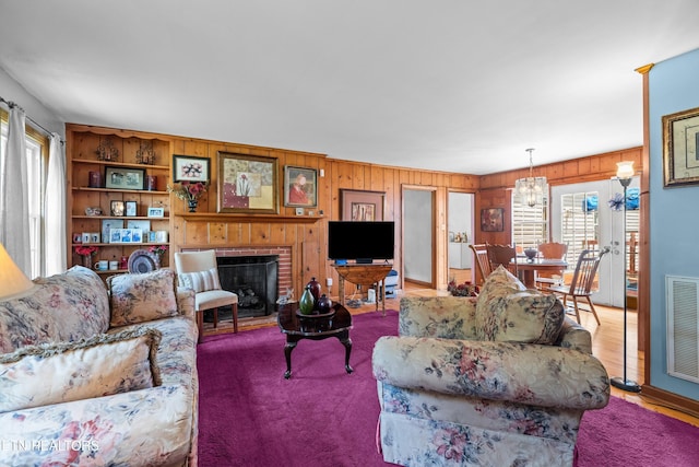 5400 Parkdale Rd, Knoxville, TN 37912 - living area featuring wooden walls, a brick fireplace, and a chandelier