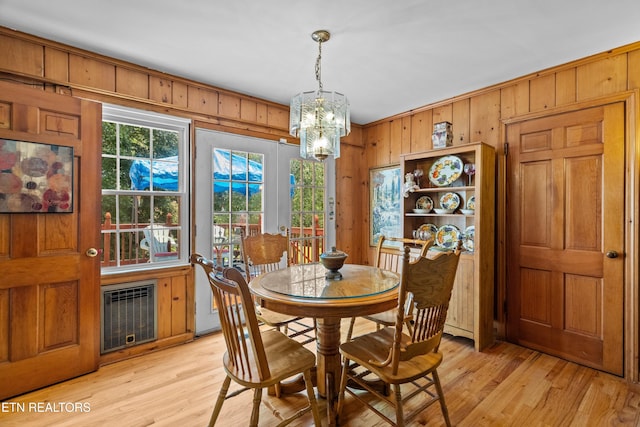5400 Parkdale Rd, Knoxville, TN 37912 - dining room featuring a chandelier, wooden walls, and light wood-style flooring