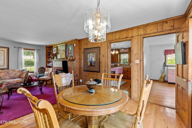 5400 Parkdale Rd, Knoxville, TN 37912 - dining area with a chandelier, plenty of natural light, wood walls, light wood finished floors, and a fireplace