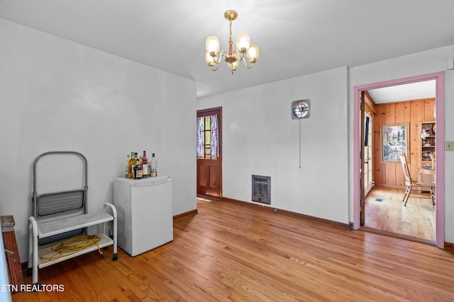 5400 Parkdale Rd, Knoxville, TN 37912 - living area with light wood-style flooring, a chandelier, heating unit, and wood walls