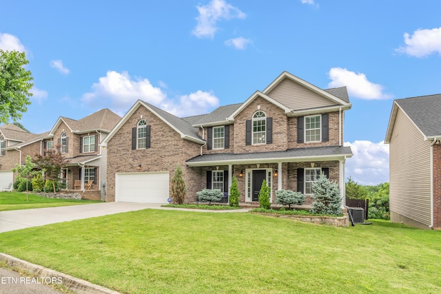 6126 Hollow View Ln, Knoxville, TN 37924 - view of front of property with brick siding, an attached garage, concrete driveway, a porch, and a front yard