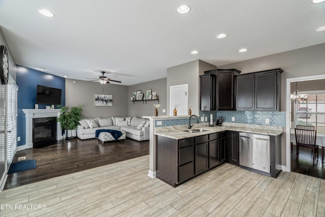 6126 Hollow View Ln, Knoxville, TN 37924 - kitchen featuring stainless steel dishwasher, light wood-style flooring, a ceiling fan, a peninsula, and light stone countertops