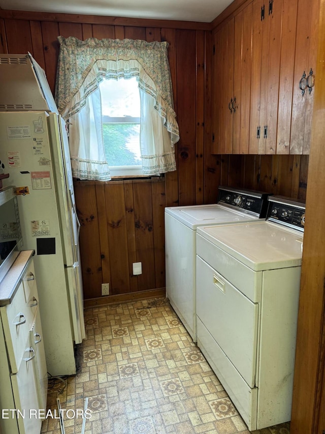 2101 NW Chillicothe St, Knoxville, TN 37921 - washroom with washing machine and clothes dryer, brick patterned flooring, and wood walls