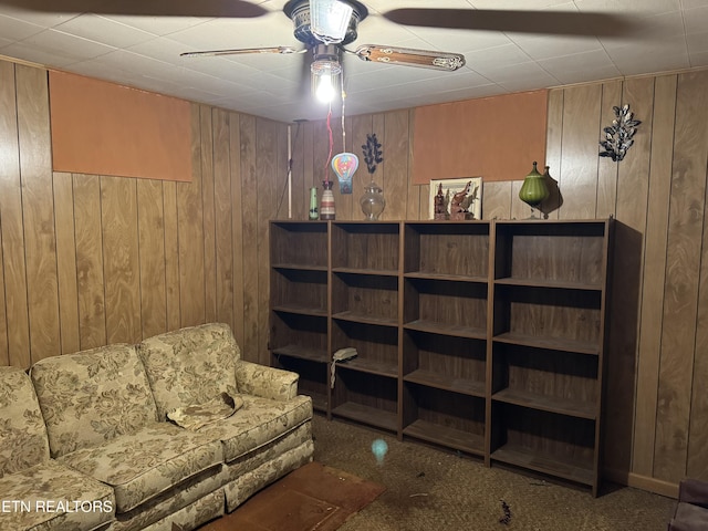 2101 NW Chillicothe St, Knoxville, TN 37921 - living area with wooden walls, carpet floors, and a ceiling fan