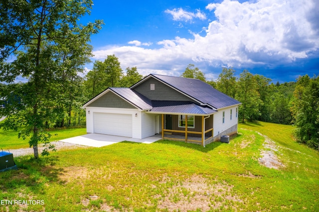 760 Rockview Rd, Jamestown, TN 38556 - view of front of property featuring driveway, covered porch, a front lawn, a garage, and a metal roof