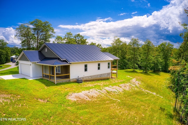 760 Rockview Rd, Jamestown, TN 38556 - view of side of property with an attached garage, a yard, a metal roof, and concrete driveway