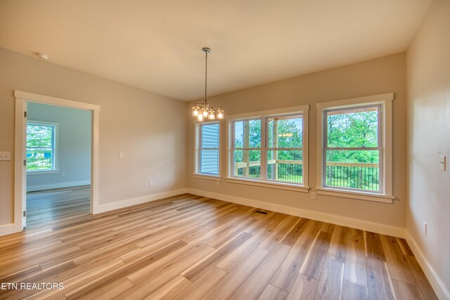 760 Rockview Rd, Jamestown, TN 38556 - unfurnished room featuring plenty of natural light, a chandelier, and light wood-type flooring