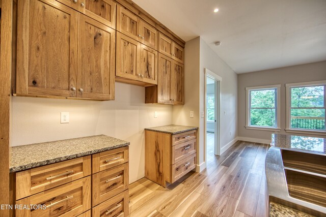 760 Rockview Rd, Jamestown, TN 38556 - kitchen with light wood-style flooring, light stone countertops, plenty of natural light, brown cabinets, and recessed lighting