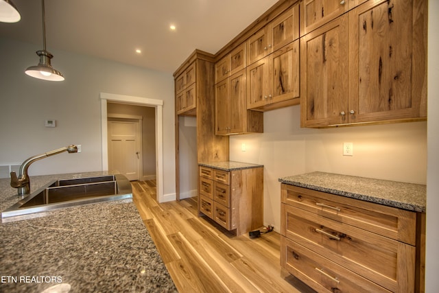 760 Rockview Rd, Jamestown, TN 38556 - kitchen with brown cabinets, light wood-type flooring, dark stone counters, hanging light fixtures, and recessed lighting