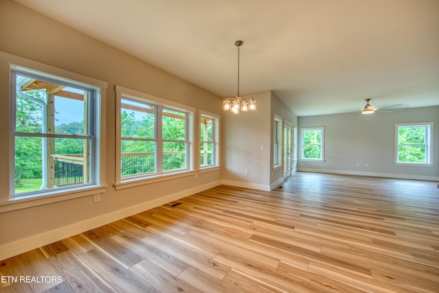 760 Rockview Rd, Jamestown, TN 38556 - spare room with a chandelier, plenty of natural light, light wood-type flooring, and a ceiling fan