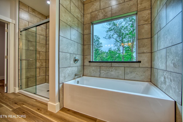 760 Rockview Rd, Jamestown, TN 38556 - bathroom featuring wood finished floors, a garden tub, and a stall shower