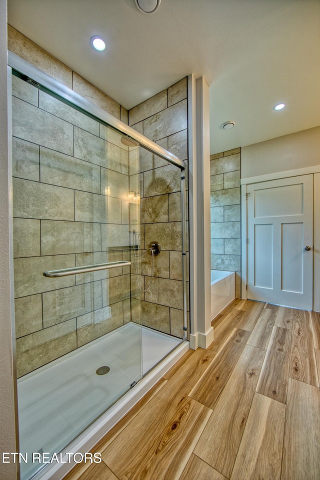 760 Rockview Rd, Jamestown, TN 38556 - bathroom with a stall shower, wood finished floors, a bath, and recessed lighting