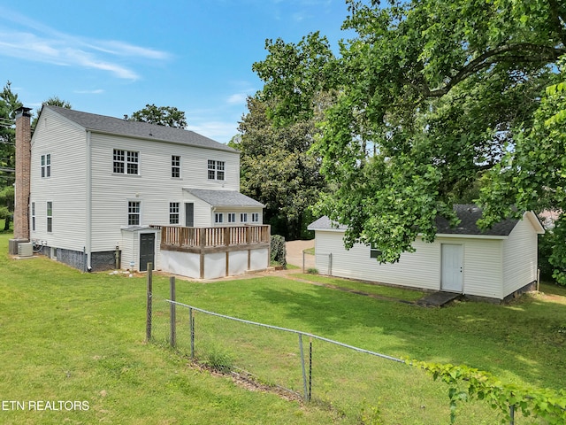 1100 Cedar Ln, Knoxville, TN 37912 - rear view of house featuring a fenced backyard, an outbuilding, a deck, and roof with shingles
