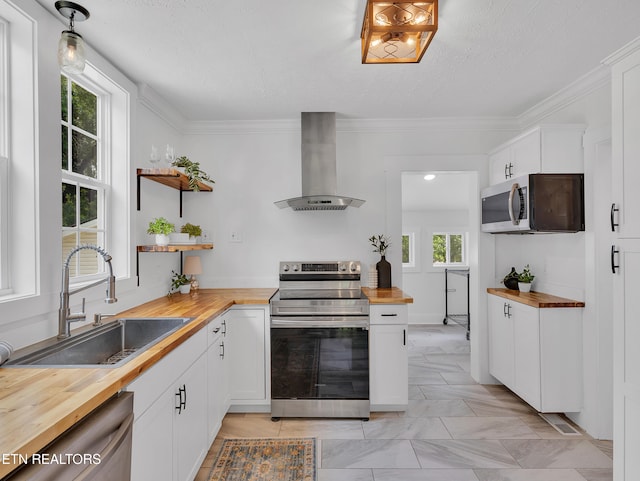 1100 Cedar Ln, Knoxville, TN 37912 - kitchen with butcher block countertops, wall chimney range hood, stainless steel appliances, open shelves, and white cabinets
