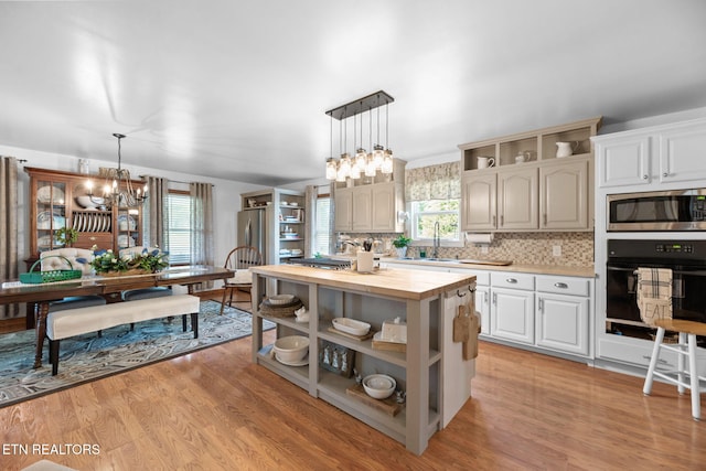 1292 Deer Lodge Hwy, Sunbright, TN 37872 - kitchen featuring appliances with stainless steel finishes, open shelves, a chandelier, and wood counters