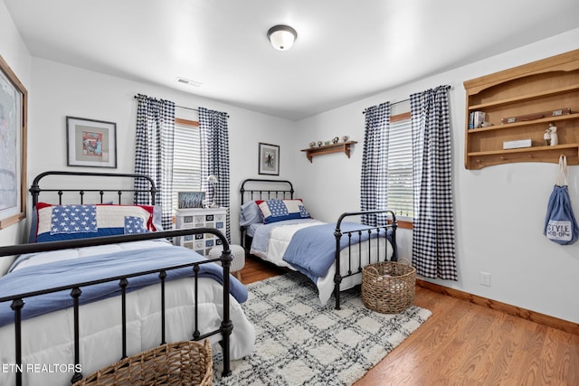 1292 Deer Lodge Hwy, Sunbright, TN 37872 - bedroom featuring multiple windows and wood finished floors