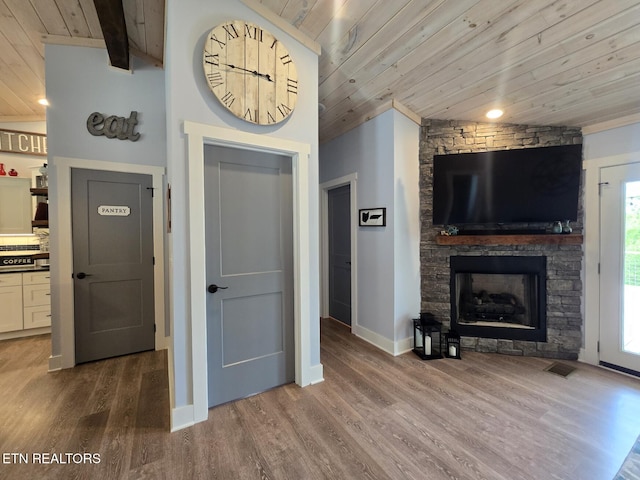 669 Crooked Branch Pvt Rd, Huntsville, TN 37756 - living room with wood ceiling, wood finished floors, and a stone fireplace
