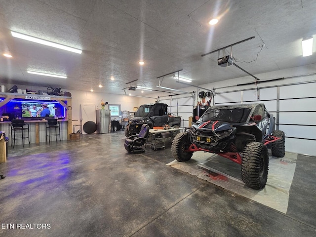 669 Crooked Branch Pvt Rd, Huntsville, TN 37756 - garage with freestanding refrigerator and a garage door opener