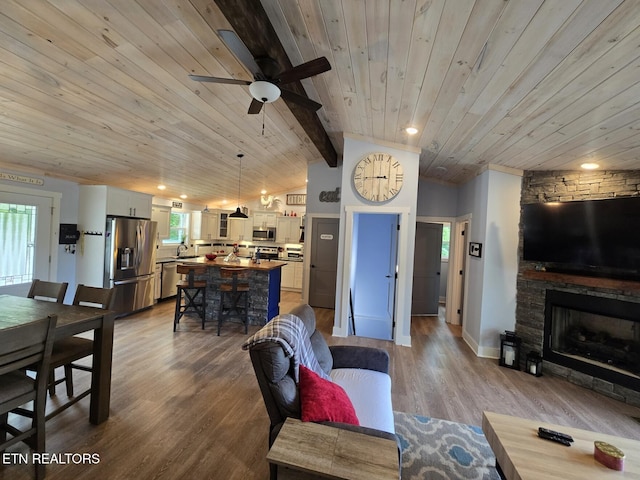 669 Crooked Branch Pvt Rd, Huntsville, TN 37756 - living room featuring wood ceiling, plenty of natural light, ceiling fan, a fireplace, and dark wood-style flooring