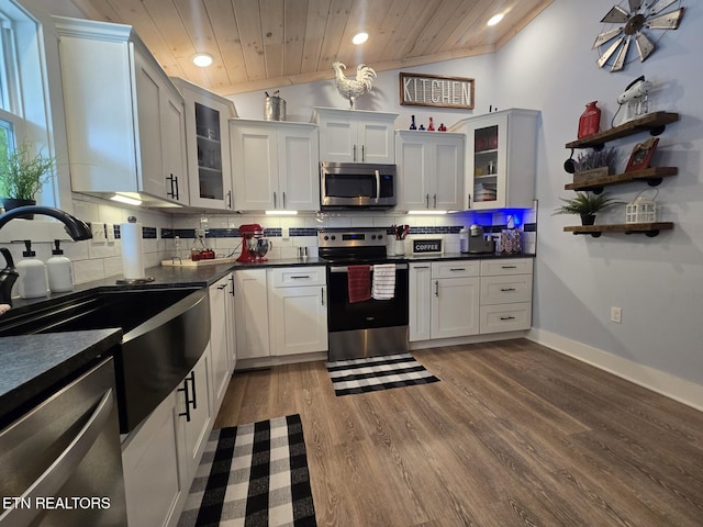 669 Crooked Branch Pvt Rd, Huntsville, TN 37756 - kitchen with stainless steel appliances, wooden ceiling, dark countertops, wood finished floors, and decorative backsplash
