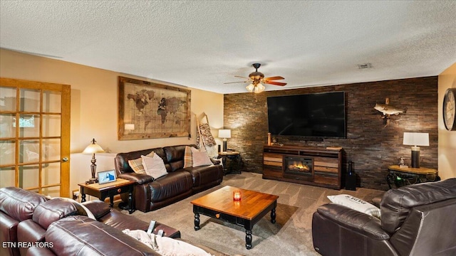 573 Hilltop Dr, Jacksboro, TN 37757 - carpeted living room with a ceiling fan, a textured ceiling, and a glass covered fireplace