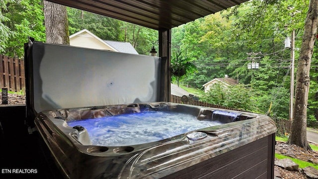 573 Hilltop Dr, Jacksboro, TN 37757 - view of patio / terrace with a hot tub and a wooded view