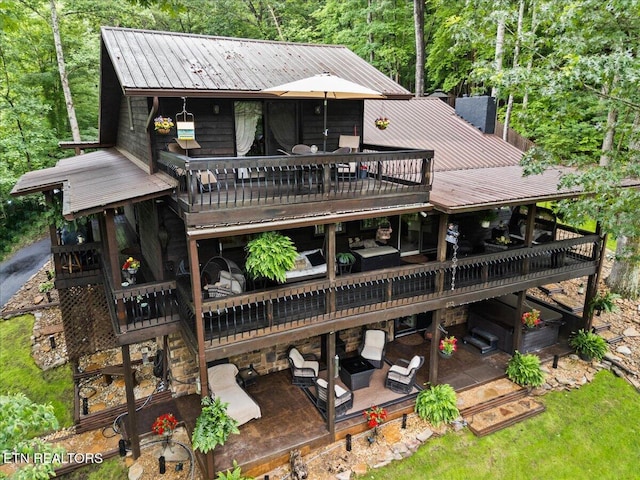 573 Hilltop Dr, Jacksboro, TN 37757 - back of house featuring a metal roof, a wooden deck, a patio area, and a wooded view