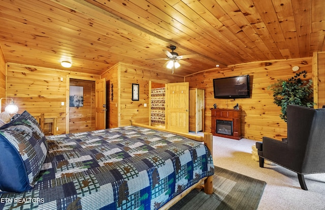 1930 Orchard Dr, Sevierville, TN 37876 - bedroom featuring carpet floors, wood walls, vaulted ceiling, and a glass covered fireplace