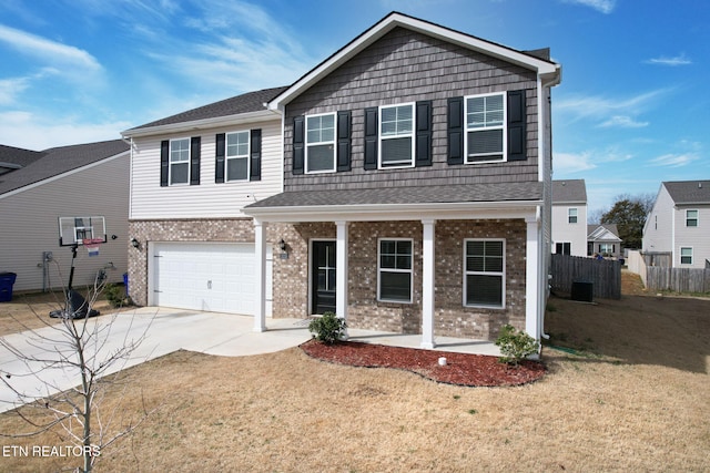 3235 NE Rolling Meadow Way, Cleveland, TN 37323 - view of front of house featuring brick siding, an attached garage, concrete driveway, and covered porch