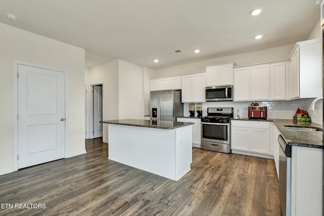 3235 NE Rolling Meadow Way, Cleveland, TN 37323 - kitchen with appliances with stainless steel finishes, a kitchen island, dark wood-type flooring, white cabinets, and recessed lighting