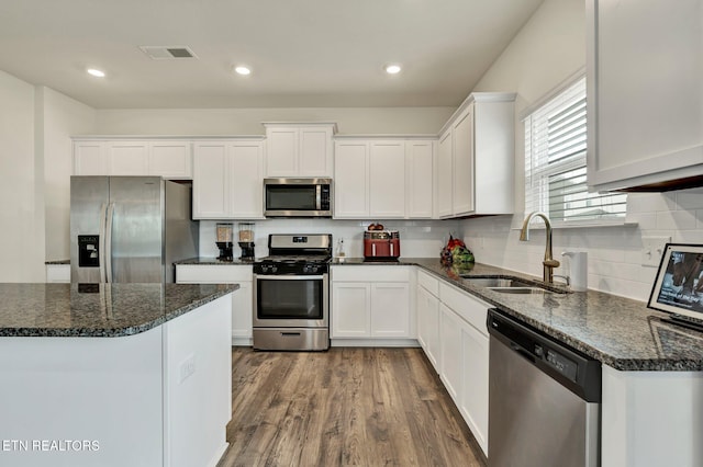 3235 NE Rolling Meadow Way, Cleveland, TN 37323 - kitchen featuring stainless steel appliances, white cabinetry, dark wood-type flooring, backsplash, and recessed lighting