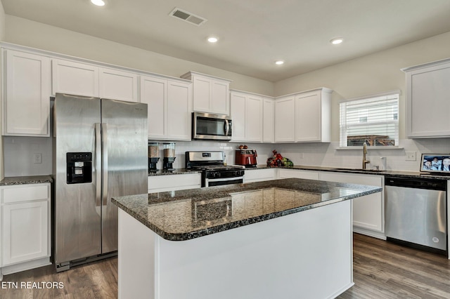 3235 NE Rolling Meadow Way, Cleveland, TN 37323 - kitchen featuring stainless steel appliances, white cabinets, backsplash, dark wood-style flooring, and recessed lighting