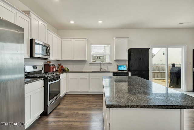 3235 NE Rolling Meadow Way, Cleveland, TN 37323 - kitchen with stainless steel appliances, white cabinets, a center island, decorative backsplash, and recessed lighting