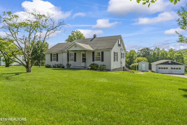 7518 Clapps Chapel Rd, Corryton, TN 37721 - view of front of house featuring an outbuilding, a detached garage, a front yard, a chimney, and a shingled roof