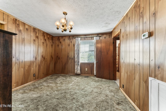 7518 Clapps Chapel Rd, Corryton, TN 37721 - carpeted empty room with a chandelier, wood walls, and a textured ceiling