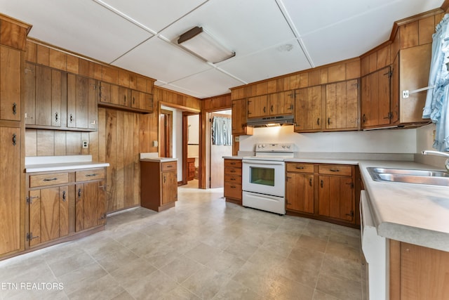 7518 Clapps Chapel Rd, Corryton, TN 37721 - kitchen featuring white appliances, under cabinet range hood, brown cabinetry, wood walls, and light countertops