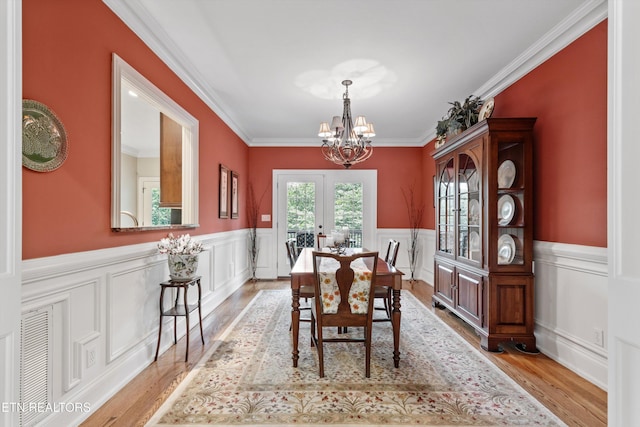 232 Park Meade Pl, Oak Ridge, TN 37830 - dining room with a chandelier, ornamental molding, a wainscoted wall, and wood finished floors