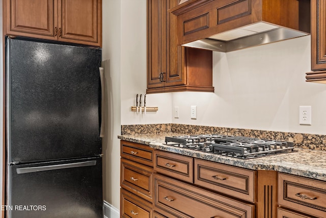 232 Park Meade Pl, Oak Ridge, TN 37830 - kitchen featuring black appliances, premium range hood, brown cabinets, and light stone counters