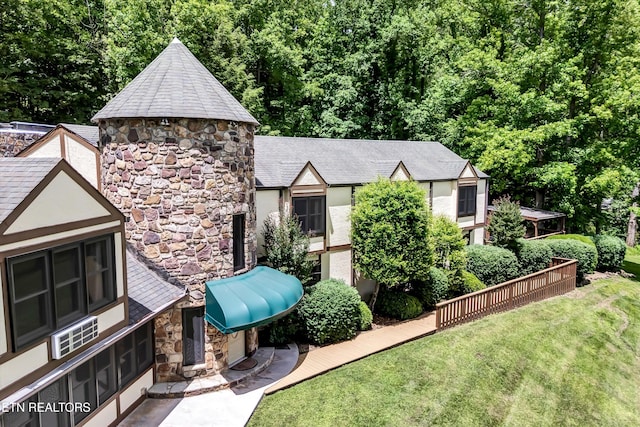 3950 Castle Rd, Gatlinburg, TN 37738 - view of front facade with stone siding, a front yard, and stucco siding