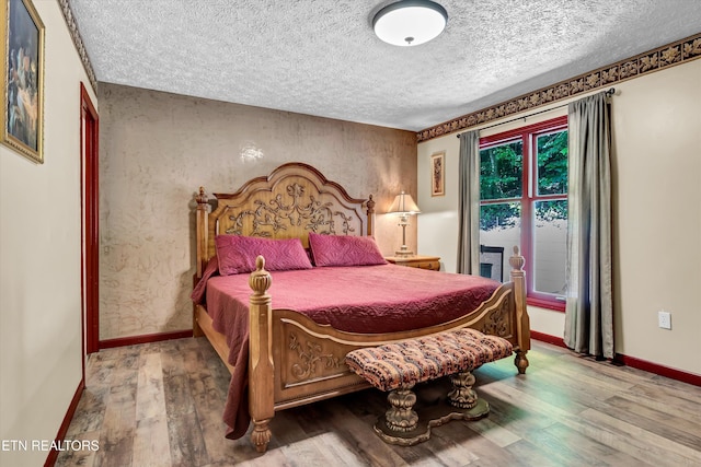 3950 Castle Rd, Gatlinburg, TN 37738 - bedroom with a textured ceiling and wood finished floors