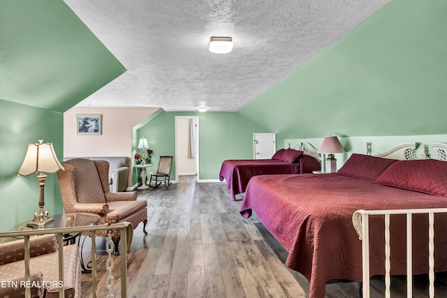 3950 Castle Rd, Gatlinburg, TN 37738 - bedroom featuring a textured ceiling, hardwood / wood-style flooring, and lofted ceiling