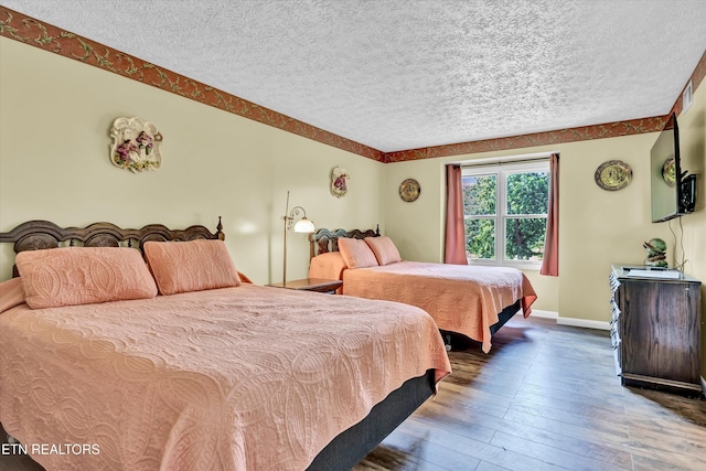 3950 Castle Rd, Gatlinburg, TN 37738 - bedroom featuring a textured ceiling and wood-type flooring