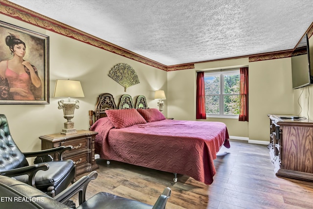 3950 Castle Rd, Gatlinburg, TN 37738 - bedroom with a textured ceiling and hardwood / wood-style floors